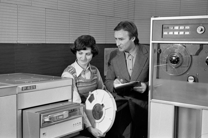 Panevėžio tiksliosios mechanikos gamyklos inžinierė programuotoja F. Petravičienė ir elektroninių skaičiavimo mašinų viršininkas A. Purtulis tikrina modernizuotos magnetinės atminties įrenginio AR-421 darbą. 1978 m. gruodžio 20 d. A. Dilio nuotrauka. Liet